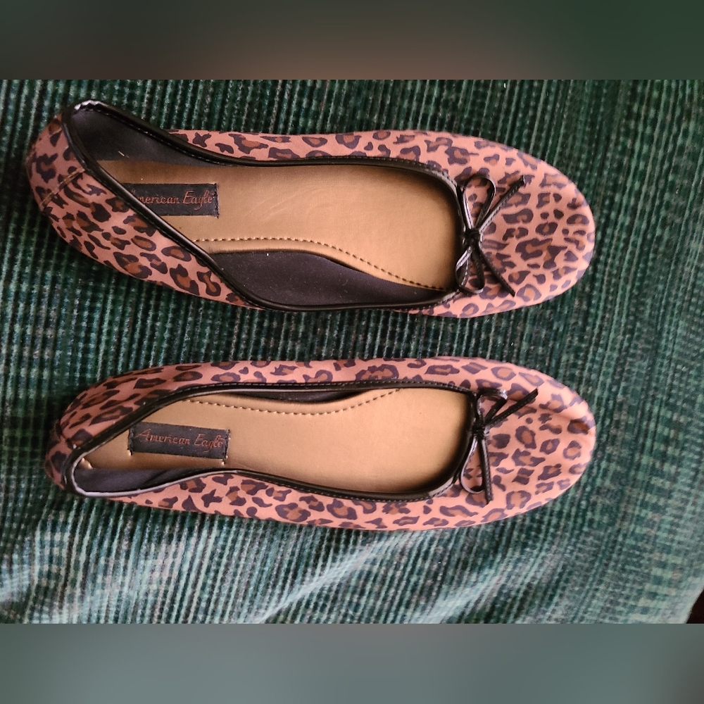 Worn only a few times, leopard flats, trimmed with patent material and bow